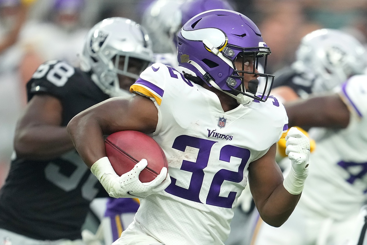 Minnesota Vikings running back Ty Chandler (32) warms up before an