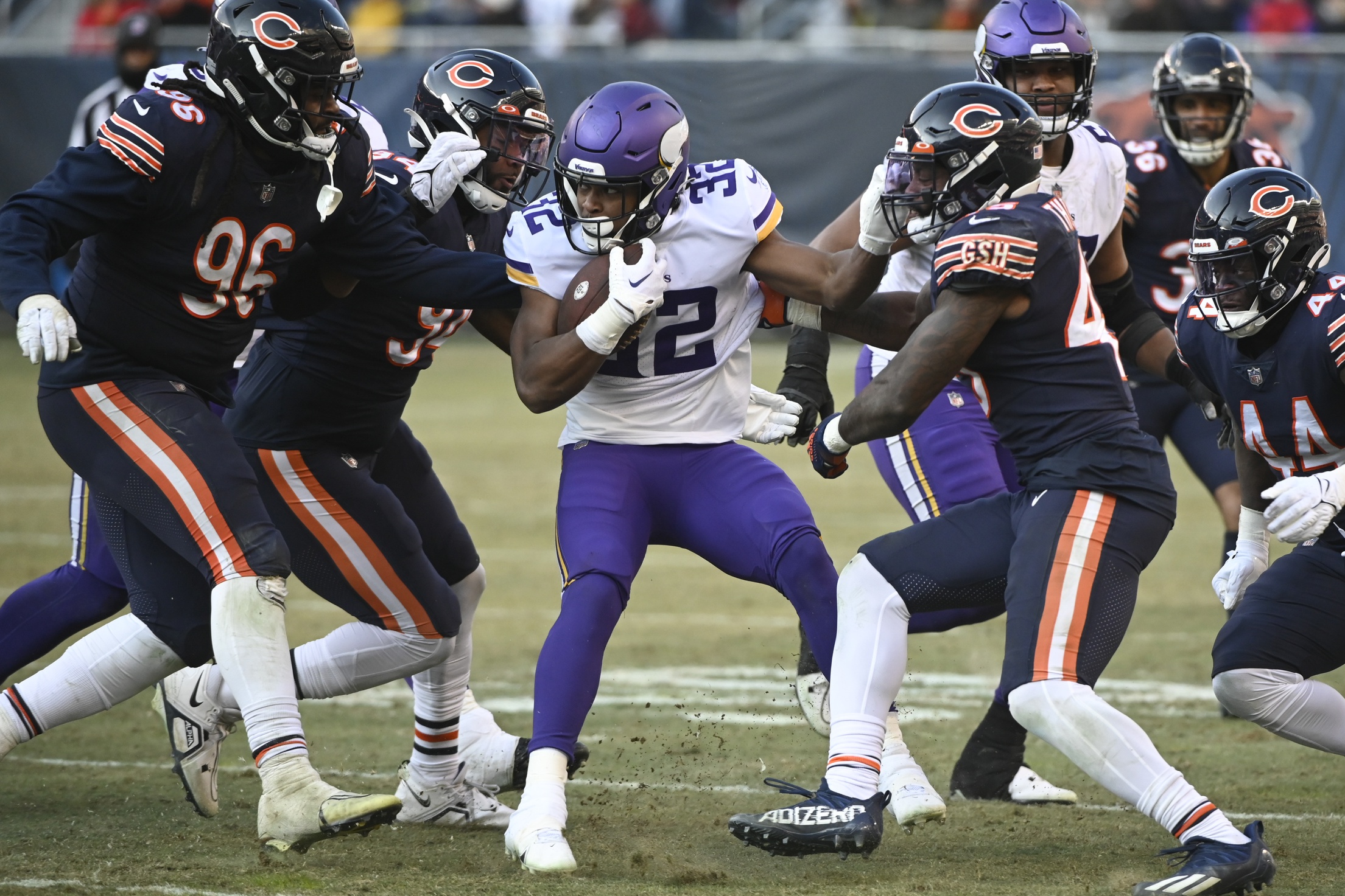 Running back Ty Chandler of the Minnesota Vikings avoids a tackle