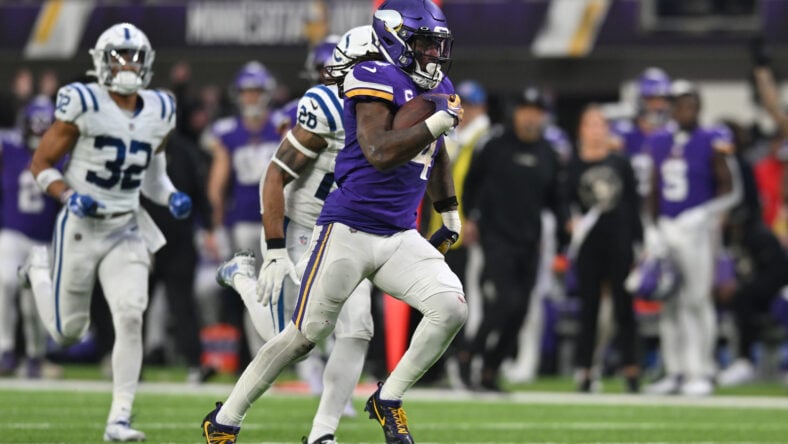 Dec 17, 2022; Minneapolis, Minnesota, USA; Minnesota Vikings running back Dalvin Cook (4) scores on a touchdown reception as Indianapolis Colts safety Rodney McLeod (26) and safety Julian Blackmon (32) pursue late during the fourth quarter at U.S. Bank Stadium.